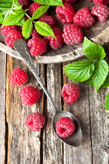Fresh and tasty looking raspberries on  wooden table