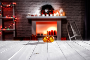 A winter composition on a wooden table in the glow of a fireplace and a Christmas tree decoration on a magical evening   