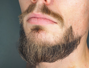 Calm anonymous caucasian male face with beard at close up