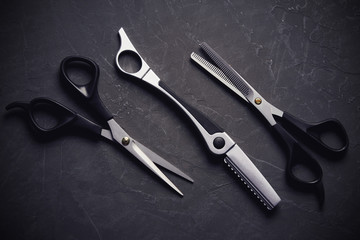 Hairdressing tools on black background with copy space at top