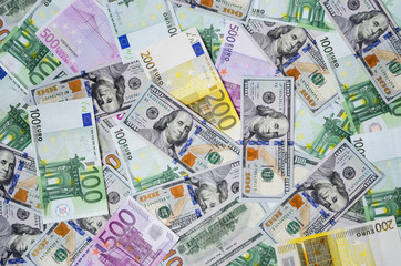 euro banknotes and dollars randomly laid out 5