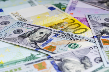 euro banknotes and dollars randomly laid out