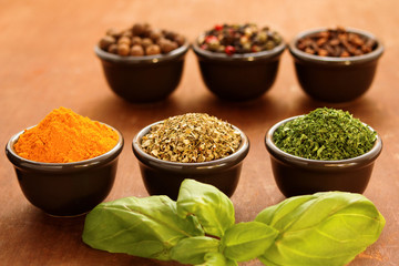 Herbs and spices on a wooden background
