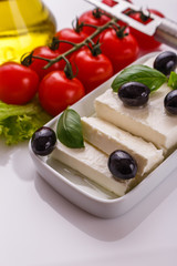 A piece of feta cheese on a white background