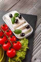 A piece of feta cheese on a wooden rustic background