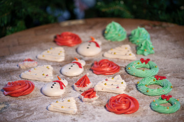 Various Christmas sweet colorful cookies with christmas tree on wood table