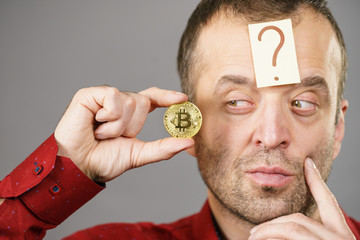 Adult man questioning bitcoin