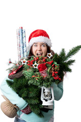 Photo of woman in Santa's cap with Christmas tree, lantern, wrapping paper in hands