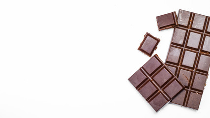 Chocolate bar, pieces on a white background. Copy space.  