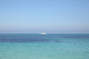 white yacht in blue sea on blue sky background without clouds. Summer concept background - Sea or Ocean Beach. With copy space for text or image. Wallpaper, postcard