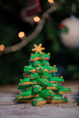 Various Christmas sweet colorful cookies with christmas tree on wood table