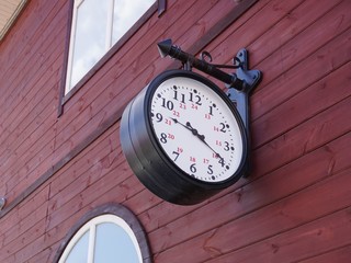 antique clock hanging on the wall of the train station