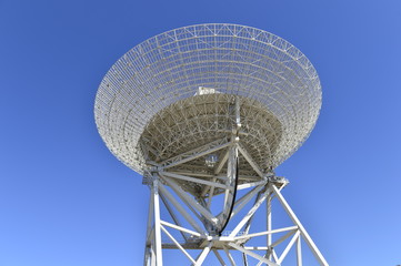 Array of satellite dishes or radio antennas against sky. Space observatory.