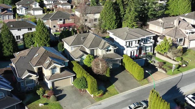 A perfect neighbourhood. Houses in suburb at Summer in the north America. Luxury houses with nice landscape. Aerial drone view.