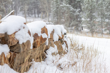 Small landscaped rock wall with snow 