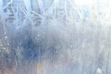 Frozen winter window with shiny ice frost pattern texture. Christmas wonder symbol, abstract background. Extreme north low temperature, natural Ice snow on frosty glass, cool winter weather outdoor