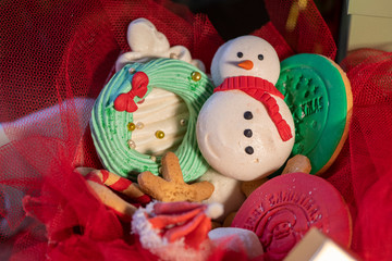 Various Christmas sweet colorful cookies with christmas tree on wood table