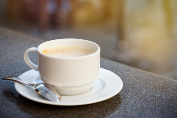 A cup of coffee on table outdoor in restaurant