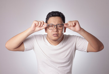 Young Man Adjusting His Eyeglasses