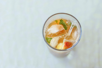 Glass of drink with fruits, ice and pimm's