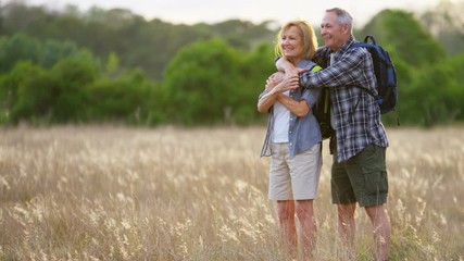 Happy Caucasian European seniors outdoors enjoying leisure hiking in the countryside outdoors 