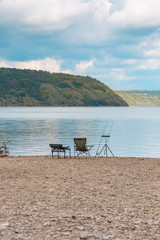 Calm fishing on the river near forest