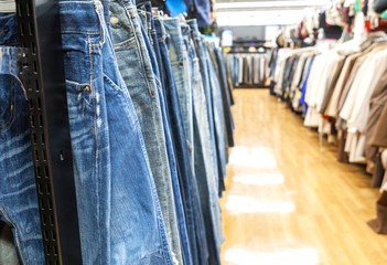 Abstract blurred  of Jeans and Clothing fashion hanging on a rack in  fashion store for background.