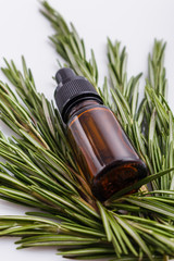 Rosemary essential oil on a white background