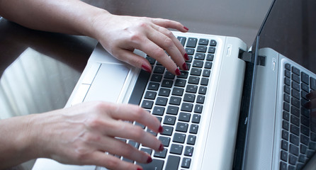 Woman typing on laptop pc