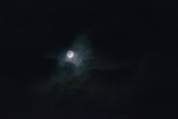 Naklejka na ściany i meble full moon behind clouds