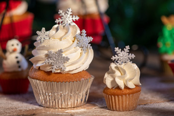 Various colorful Christmas cupcakes with christmas tree on wood table
