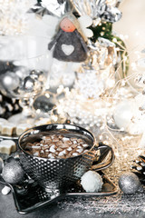Christmas, luxury xmas, silver cup of sweet cream on grey table, with sweets, cinnamon, aniseed, winter cone, and empty glass