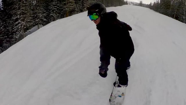 Snowboarding in Colorado Rockies at ski resort vacation
