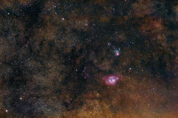 Lagoon nebula and Trifid nebula on Milky Way starry background.