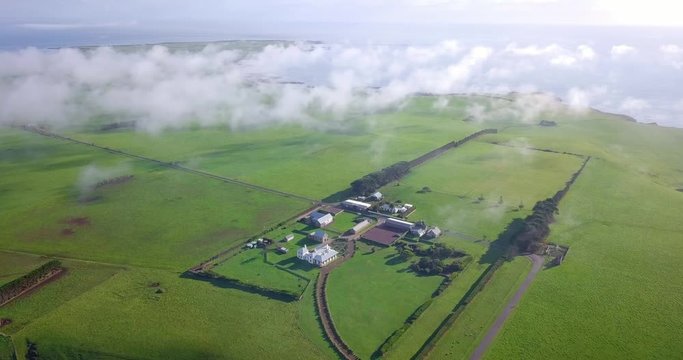 Spectacular aerial morning flight over a farmhouse in Tasmania, Australia