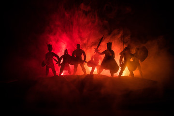 Medieval battle scene. Silhouettes of figures as separate objects, fight between warriors on dark...