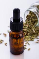 essential oil of fennel seeds on a white background