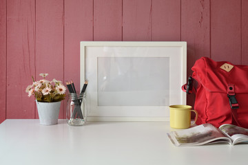 Stylish loft workspace with mockup  blank frame and home office gadget on desk table.