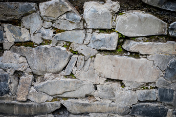 close up of a old and cracked stoned wall. Autumn time. Outdoor.