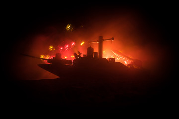 Sea battle scene. Silhouette of military war ship on dark foggy toned sky background. Explosion and...