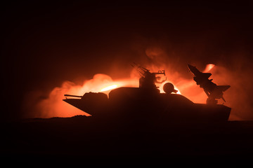 Sea battle scene. Silhouette of military war ship on dark foggy toned sky background. Explosion and...
