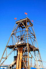 Iron ore drilling derrick in the blue sky background