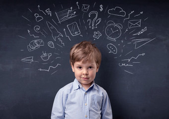 Smart little kid in front of a drawn up blackboard ruminate