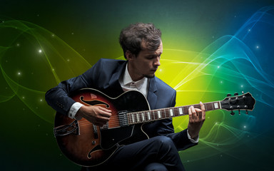 Obraz premium Serious classical guitarist with fabled sparkling wallpaper