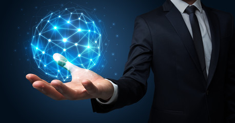 Businessman in suit holding global connection symbol on his hand