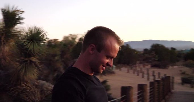 A man taking photos with an old disposable film camera and smiling on a travel adventure.