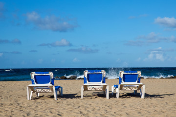 Pristine Caribbean beach with beach chairs
