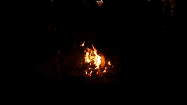People sitting around a bonfire, talking, drinking and eating on the medieval christmas market in Karlsruhe Durlach, Germany