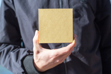 Fototapeta premium Young man holding a gift box in his hands
