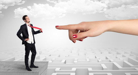 Young businessman blindly in love in the middle of an infinity maze concept
